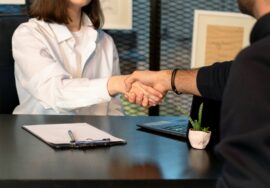 Interviewer shaking hands with job candidate.