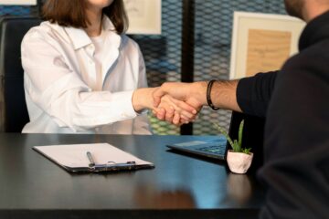 Interviewer shaking hands with job candidate.